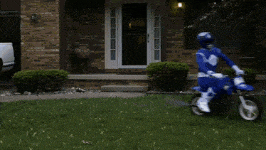 a person in a blue power ranger costume rides a motorcycle down a street