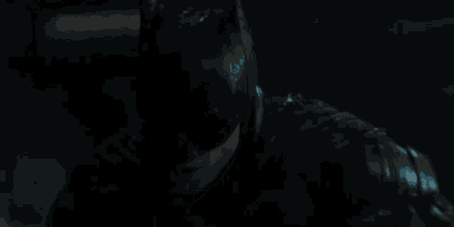 a close up of a car engine with a blue light shining on it