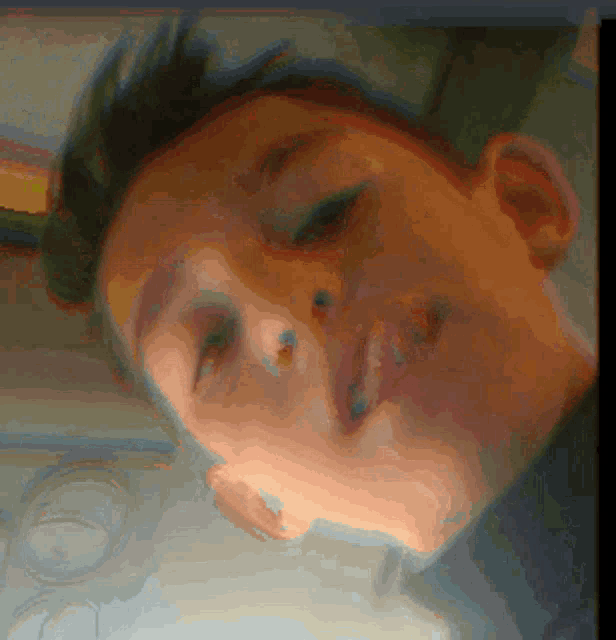 a close up of a person 's face with a few spots on it