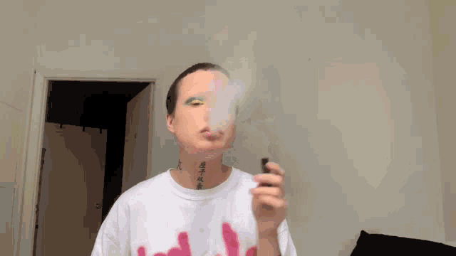 a person with a tattoo on their neck smoking a cigarette