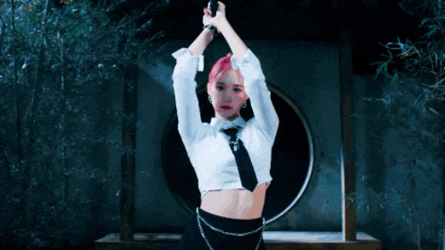 a woman with pink hair is holding a knife in her hand