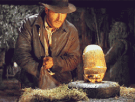 a man in a hat looks at a golden egg