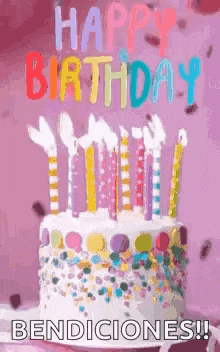 a birthday cake with candles on it and the words `` happy birthday bendiciones '' written on it .