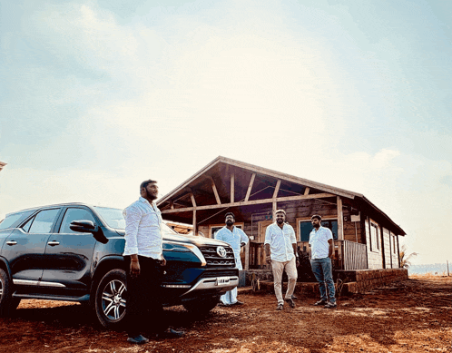 a group of men are standing in front of a toyota vehicle