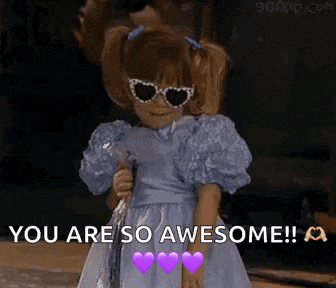 a little girl in a blue dress and heart shaped sunglasses is holding a wand and saying `` you are so awesome ! ''