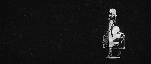 a black and white silhouette of a woman standing next to a suitcase .