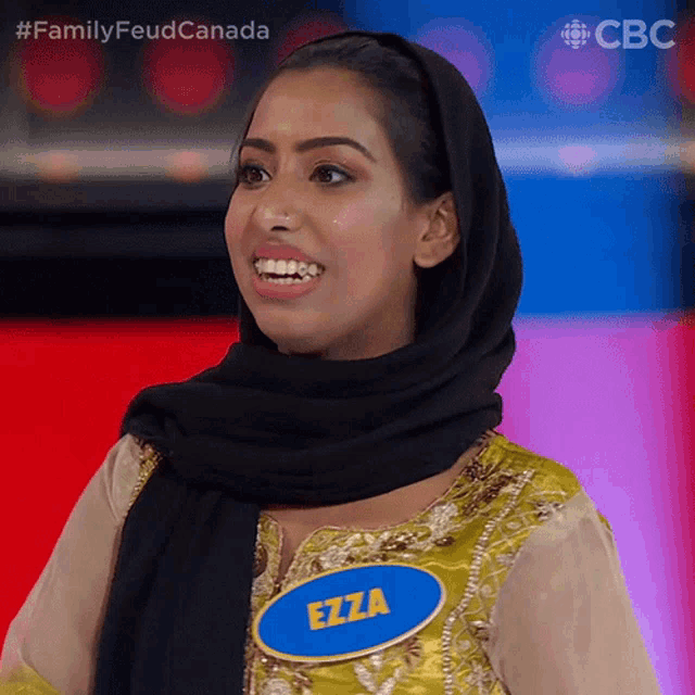 a woman with a name tag that says ezza is smiling