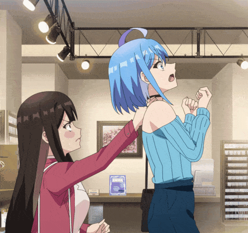 a girl in a blue sweater is standing next to a girl in a red jacket