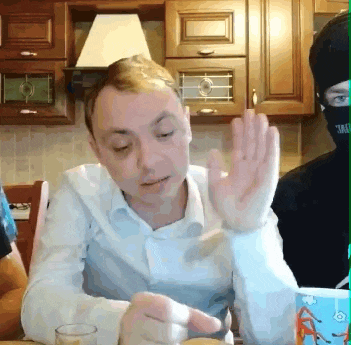 a man wearing a mask that says ' i am ' on it waves his hand