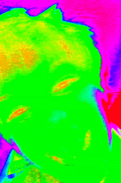 a close up of a person 's face with a rainbow of colors behind it