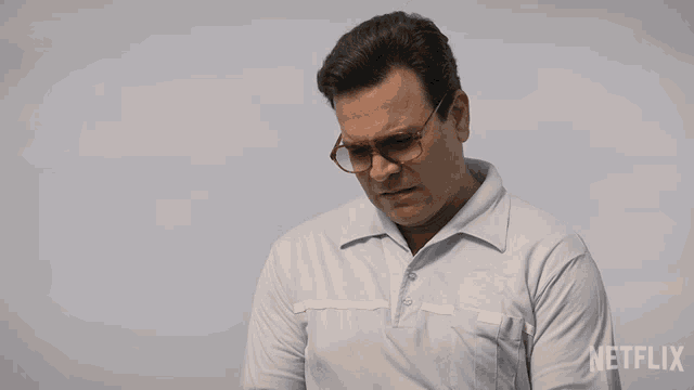 a man wearing sunglasses and a blue shirt with netflix written on the bottom