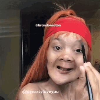 a woman wearing a red headband is applying makeup to her eyebrow