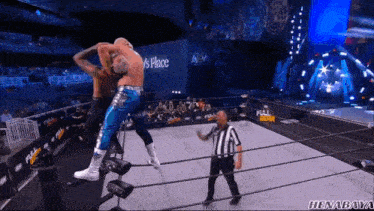 a wrestler in a blue and silver outfit is jumping in the air