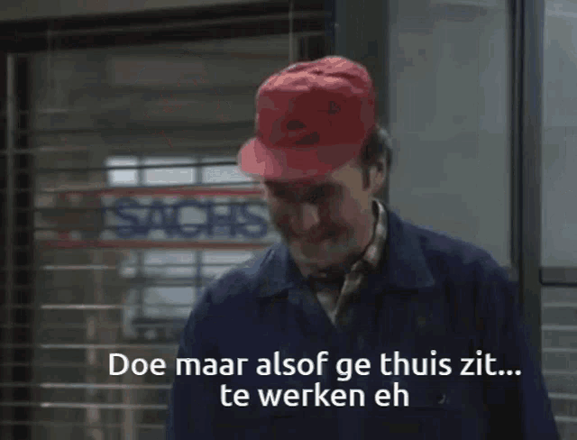 a woman sits at a desk in front of a sign that says ' doe maar alsof ge thuis zit '