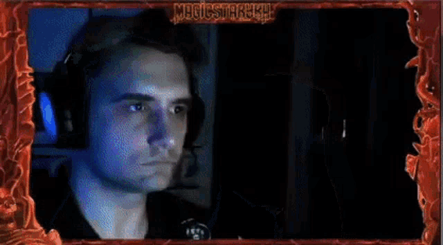 a man 's face is behind a frame that says magicstarkh on it