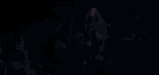 a dark room with a red light coming out of the corner