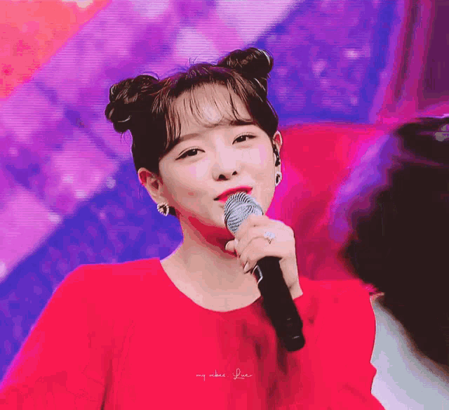 a woman in a red dress is singing into a microphone with the words my vibe love written below her