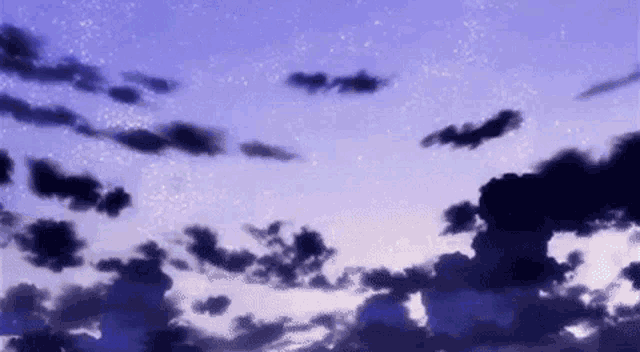 a purple sky with clouds and stars in it .