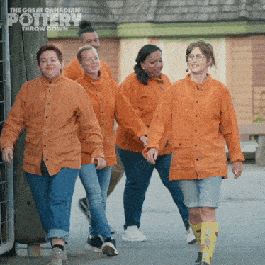 a group of people are walking down a street with the great canadian pottery throw down written on the bottom
