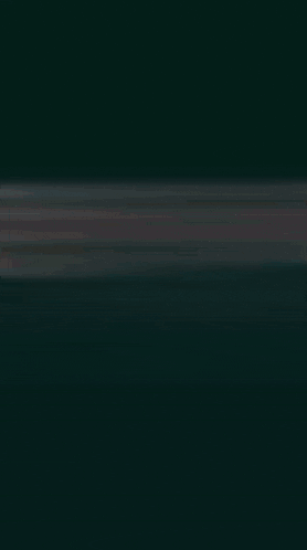 a blurry picture of a person 's hands reaching out in the dark