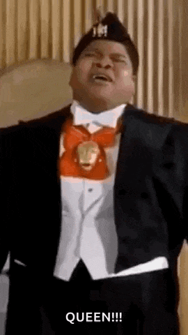 a man in a tuxedo and bow tie is dancing and singing .