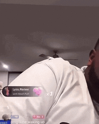 a man in a white shirt has a heart shaped sticker on his back