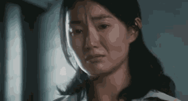 a close up of a woman 's face with her eyes closed .