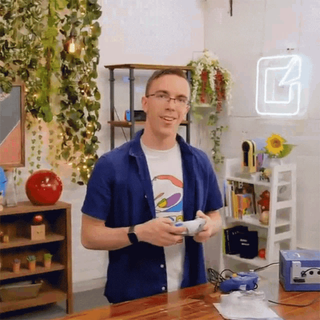 a man in a blue shirt with a pepsi shirt on is holding a video game controller