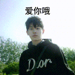 a young man wearing a black dior hoodie is standing in front of trees