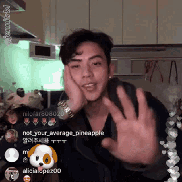 a man waving his hand in front of a screen that says nilofar808026