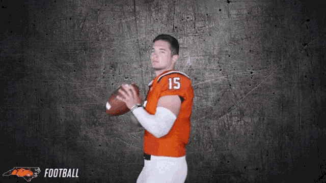 a football player with the number 15 on his jersey is holding a football