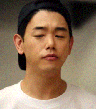 a man wearing a baseball cap and a white shirt is looking down