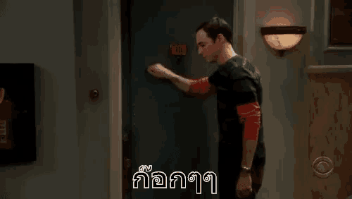 a man is knocking on a door with the number 14 on the door