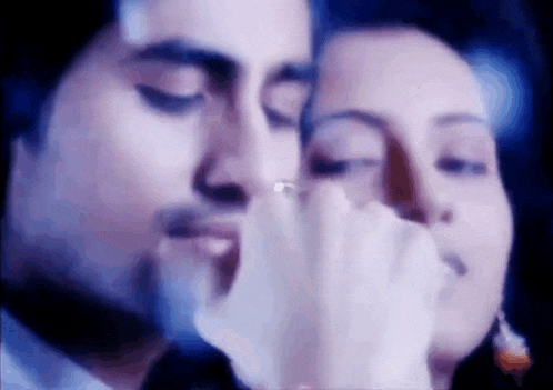 a close up of a man and woman holding hands .