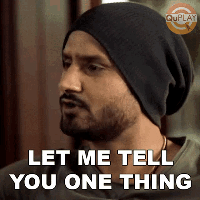 a man with a beard wearing a black beanie says let me tell you one thing