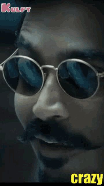 a close up of a man 's face wearing sunglasses and the word crazy below him
