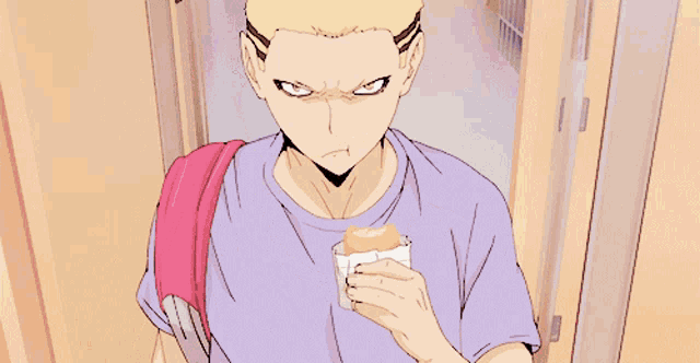 a man in a purple shirt with a pink backpack is eating a sandwich