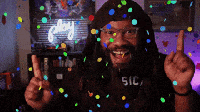 a man wearing a shirt that says sic on it is surrounded by confetti