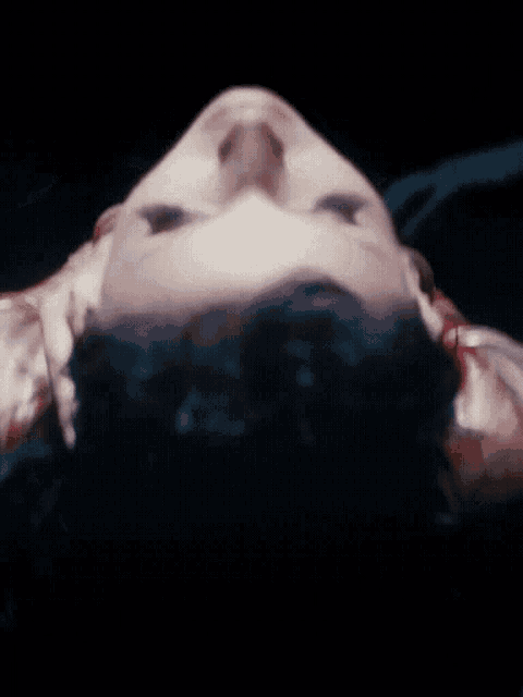 a close up of a woman 's face with a red lip