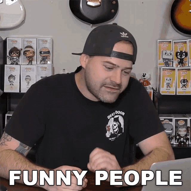 a man wearing a black shirt with a grim reaper on it says funny people