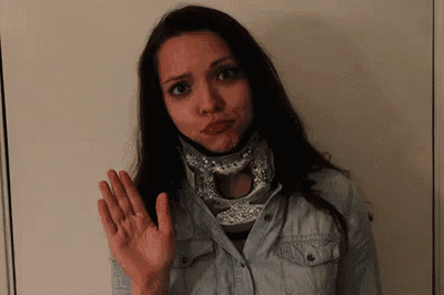 a woman wearing a neck brace is making a face
