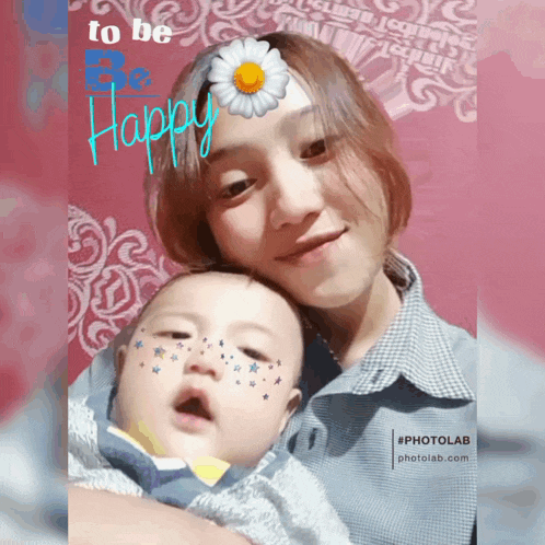 a woman holding a baby with a flower on her head and the words to be happy on the bottom