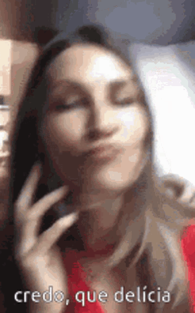 a woman is making a face while talking on a cell phone