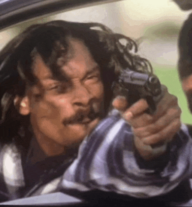 a man with a mustache is pointing a gun at another man in a car .