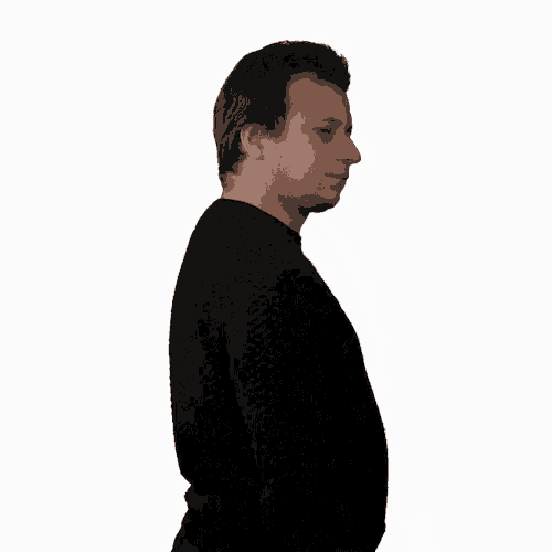a man in a black sweater is looking at the camera with a white background