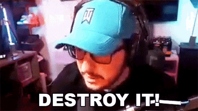 a man wearing a blue hat and headphones says " destroy it "