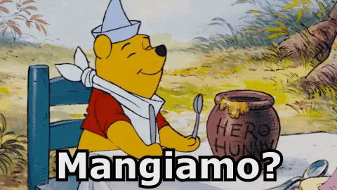 a cartoon of winnie the pooh sitting at a table with a jar of honey and the words mangiiamo below him