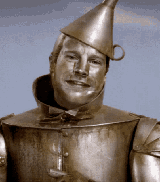 a man in a tin man costume is smiling