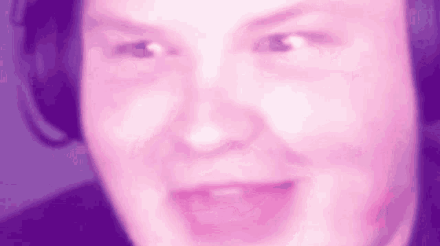 a blurry picture of a man 's face with headphones on .