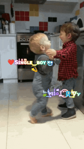 two young boys are dancing in a kitchen with the words i am single boy written on the bottom
